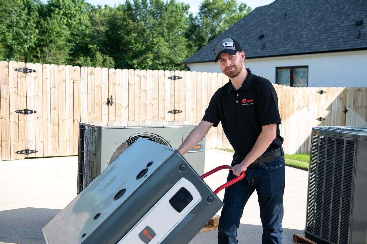 HVAC technician servicing indoor heating and cooling equipment