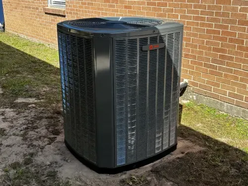 Outdoor air conditioning unit beside a home