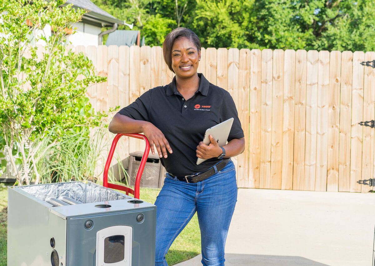 HVAC technician servicing indoor heating and cooling equipment